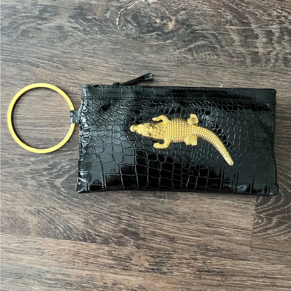 Brand new Lacoste alligator patent black wristlet with gold